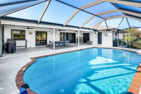 a view of a swimming pool with seating space