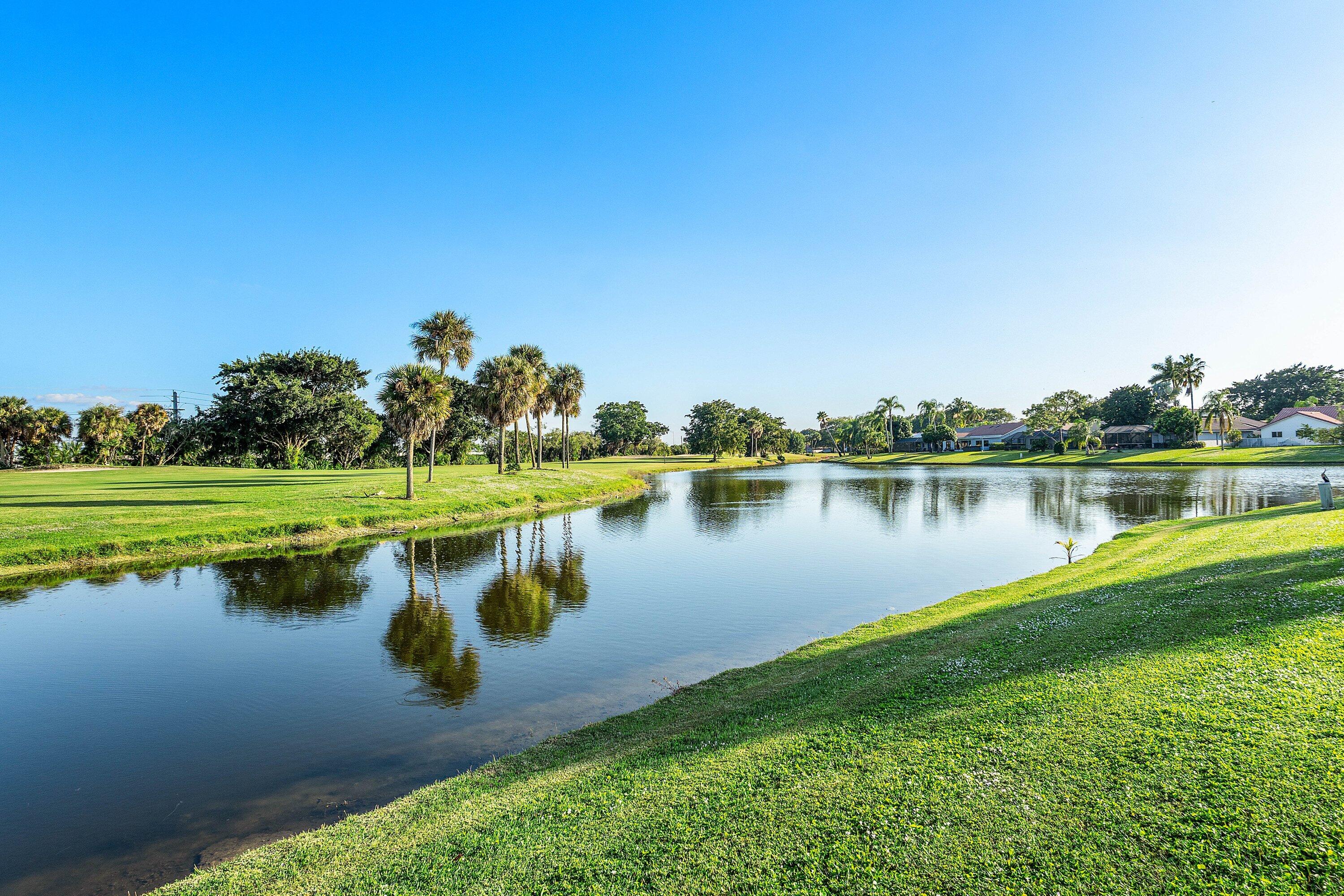 10174 Crosswind Road Boca Raton, FL 33498 - Photo 28 of 45 a view of a lake with houses in the back