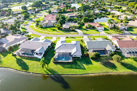 an aerial view of a house with a swimming pool yard and outdoor seating