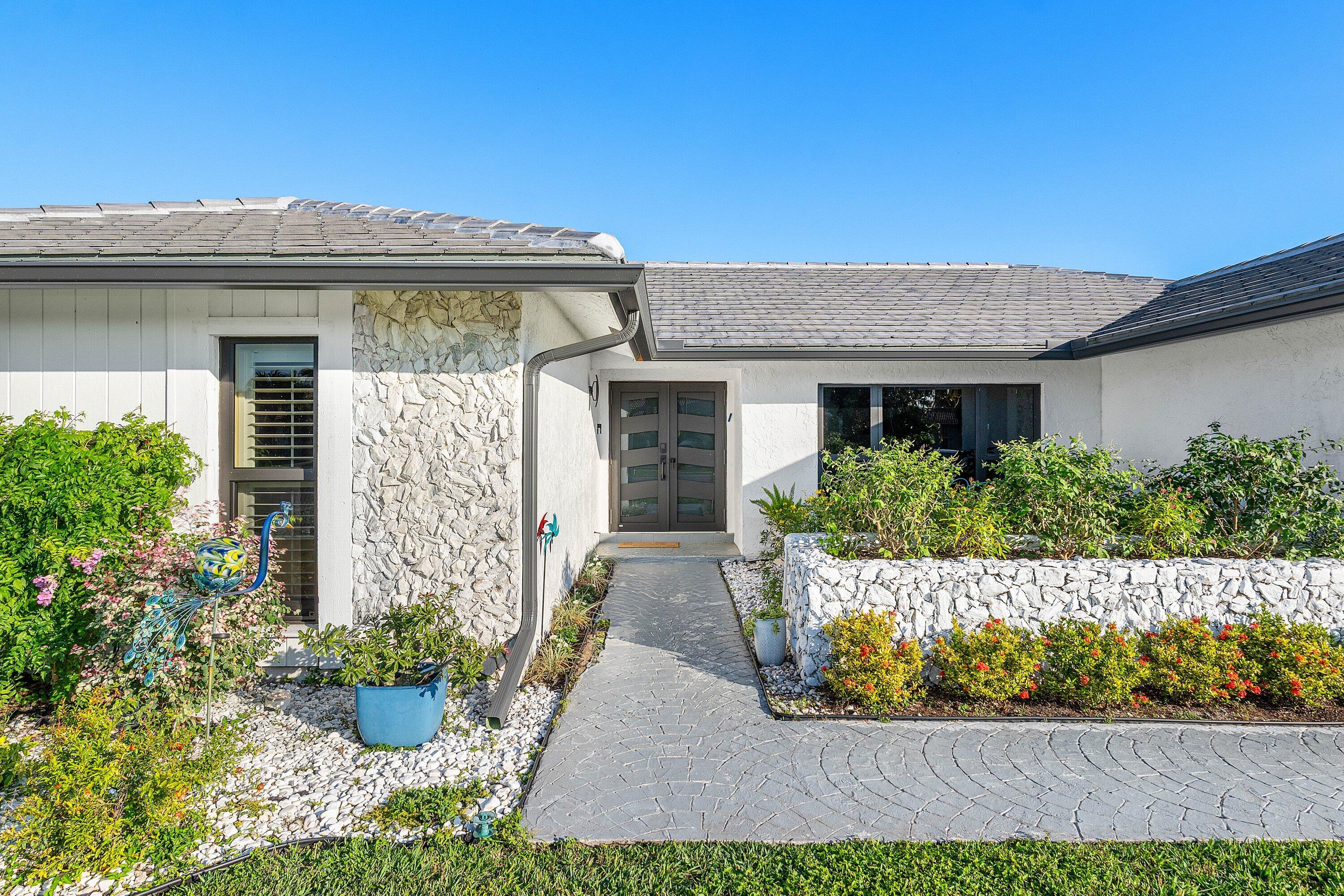 10174 Crosswind Road Boca Raton, FL 33498 - Photo 4 of 45 a front view of house with a yard