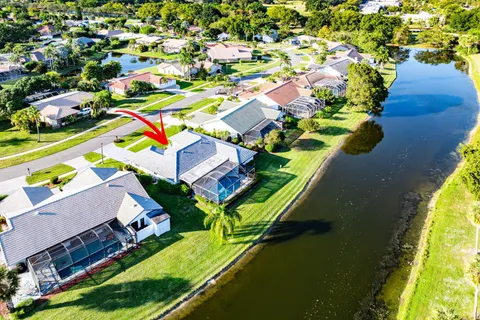 an aerial view of a house with a garden and swimming pool