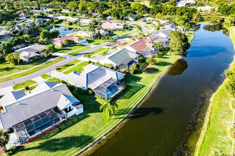 an aerial view of a house with a garden and swimming pool
