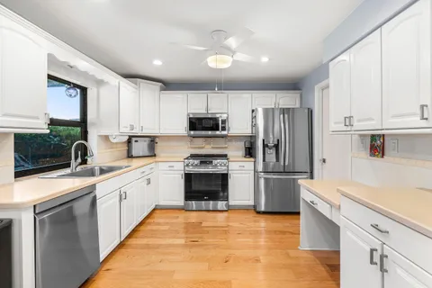 a kitchen with a sink stove and refrigerator