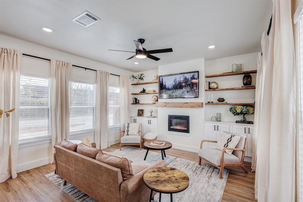 3230 6th Avenue Fort Worth, TX 76110 - Photo 11 of 37 a living room with furniture and a fireplace