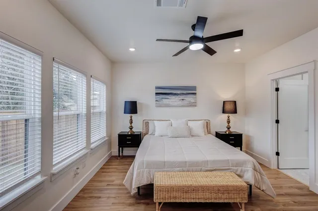 a bedroom with a bed and a large window