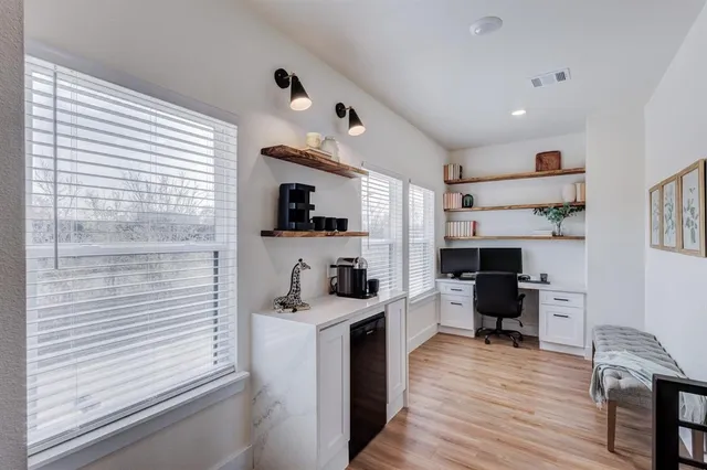 a view of a kitchen with cabinets and wooden floor