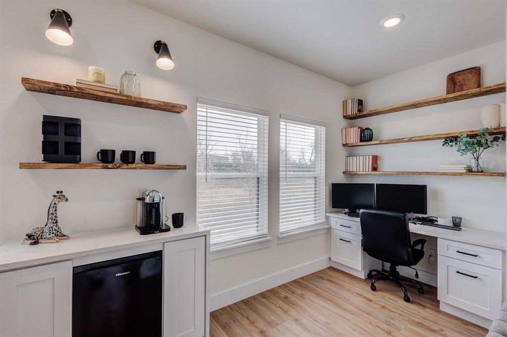 3230 6th Avenue Fort Worth, TX 76110 - Photo 25 of 37 a view of a workspace with furniture and a window