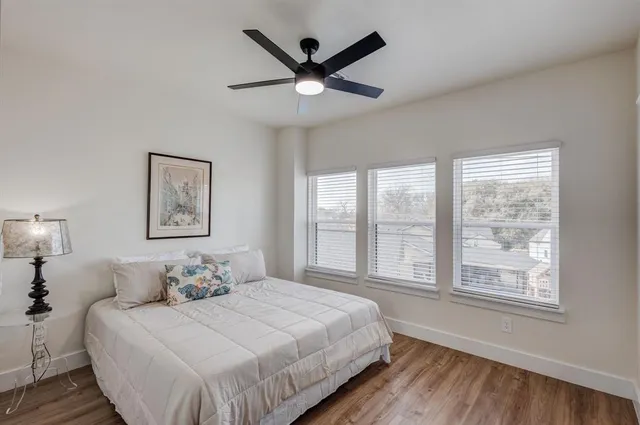 a bedroom with a large bed and a large window