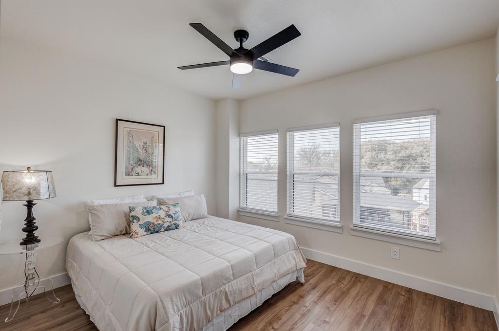 3230 6th Avenue Fort Worth, TX 76110 - Photo 26 of 37 a bedroom with a large bed and a large window