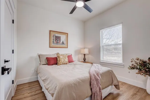 a bedroom with a bed and a window