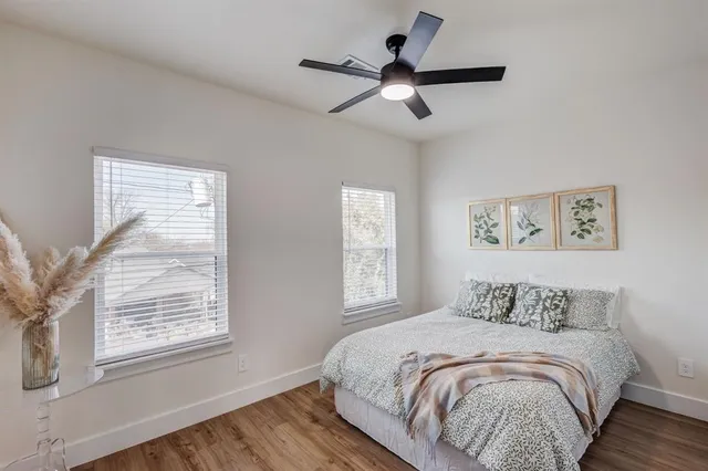 a bedroom with a large bed and a window