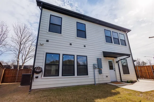 a view of a house with wooden fence