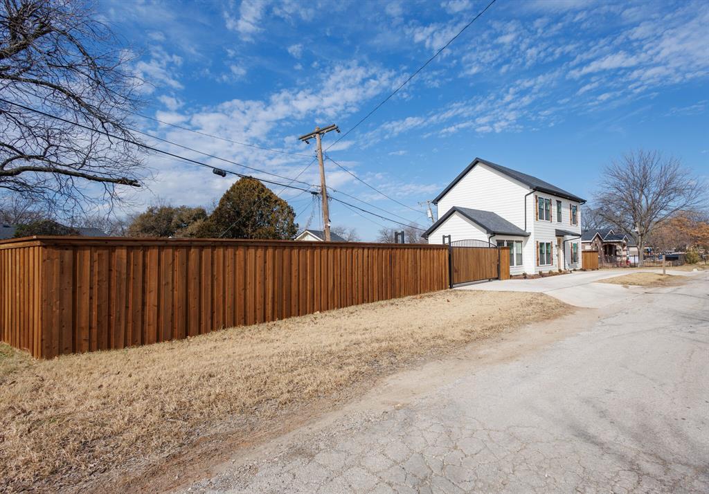 3230 6th Avenue Fort Worth, TX 76110 - Photo 4 of 37 a front view of a house with a yard