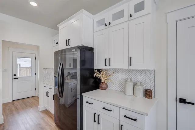 a kitchen with stainless steel appliances a refrigerator and a stove
