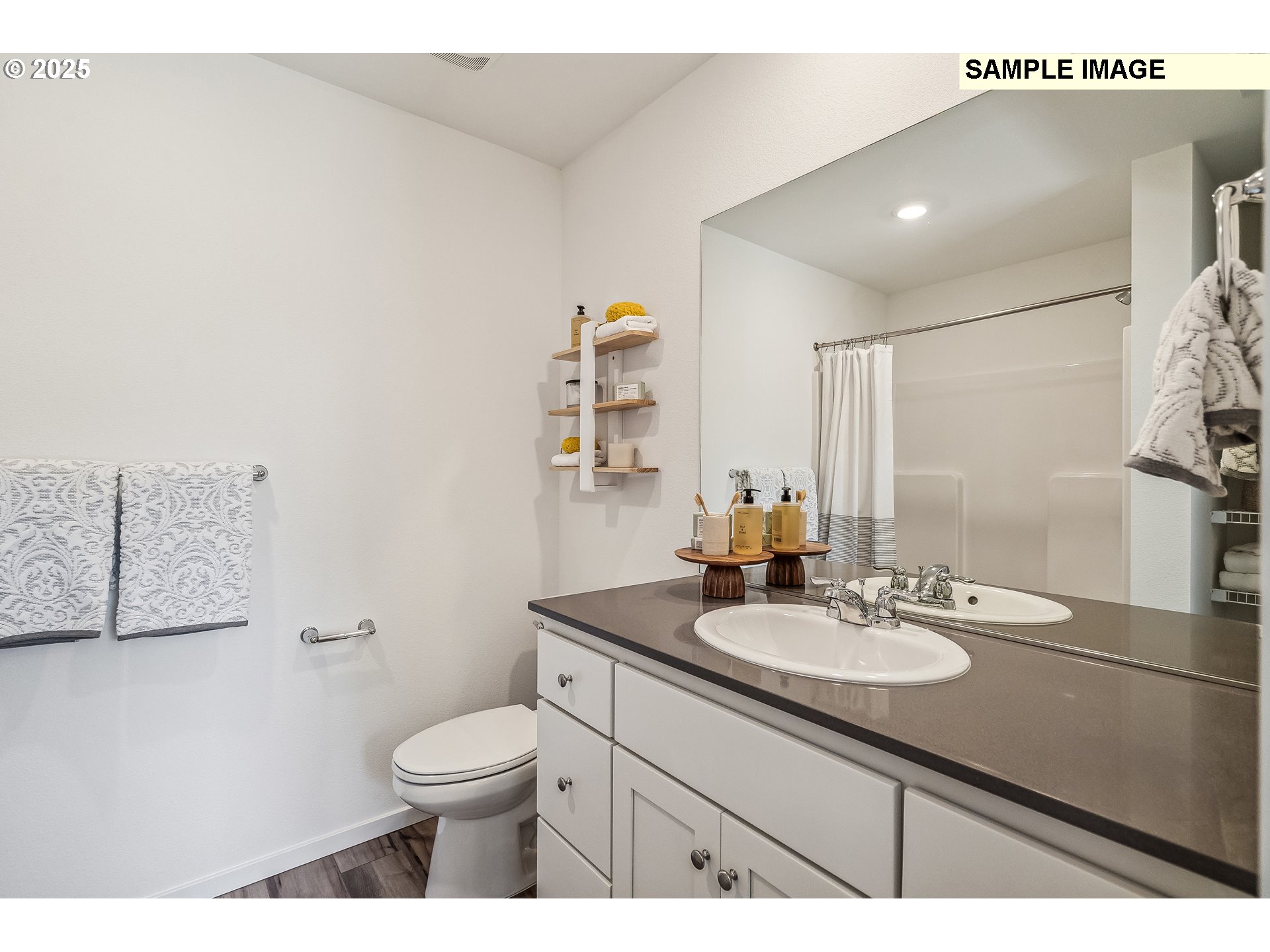 5791 Durst Street Eugene, OR 97402 - Photo 13 of 25 a bathroom with a sink a toilet and mirror