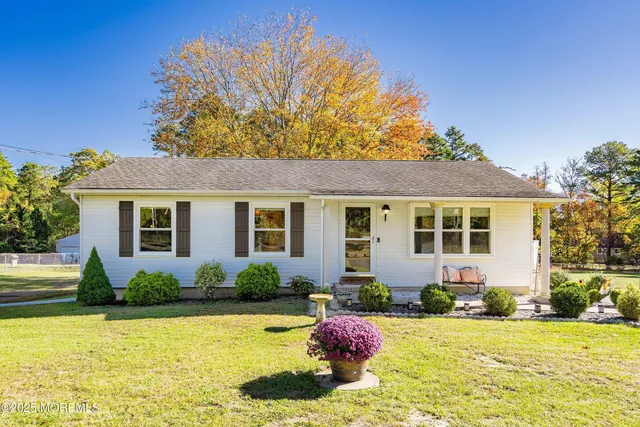 a front view of a house with swimming pool having outdoor seating