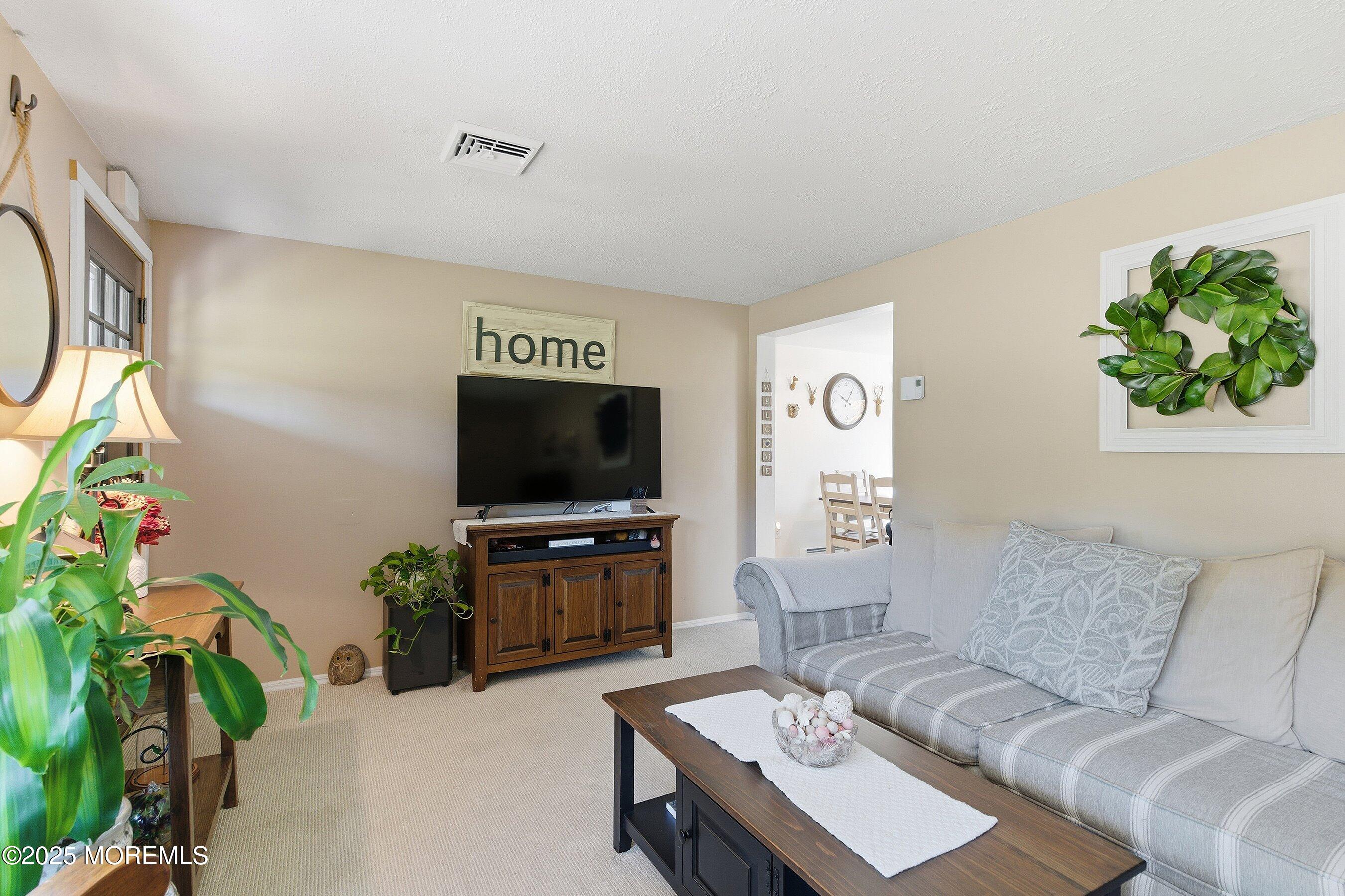 145 Cassville Road Jackson, NJ 08527 - Photo 11 of 35 a living room with furniture and a flat screen tv