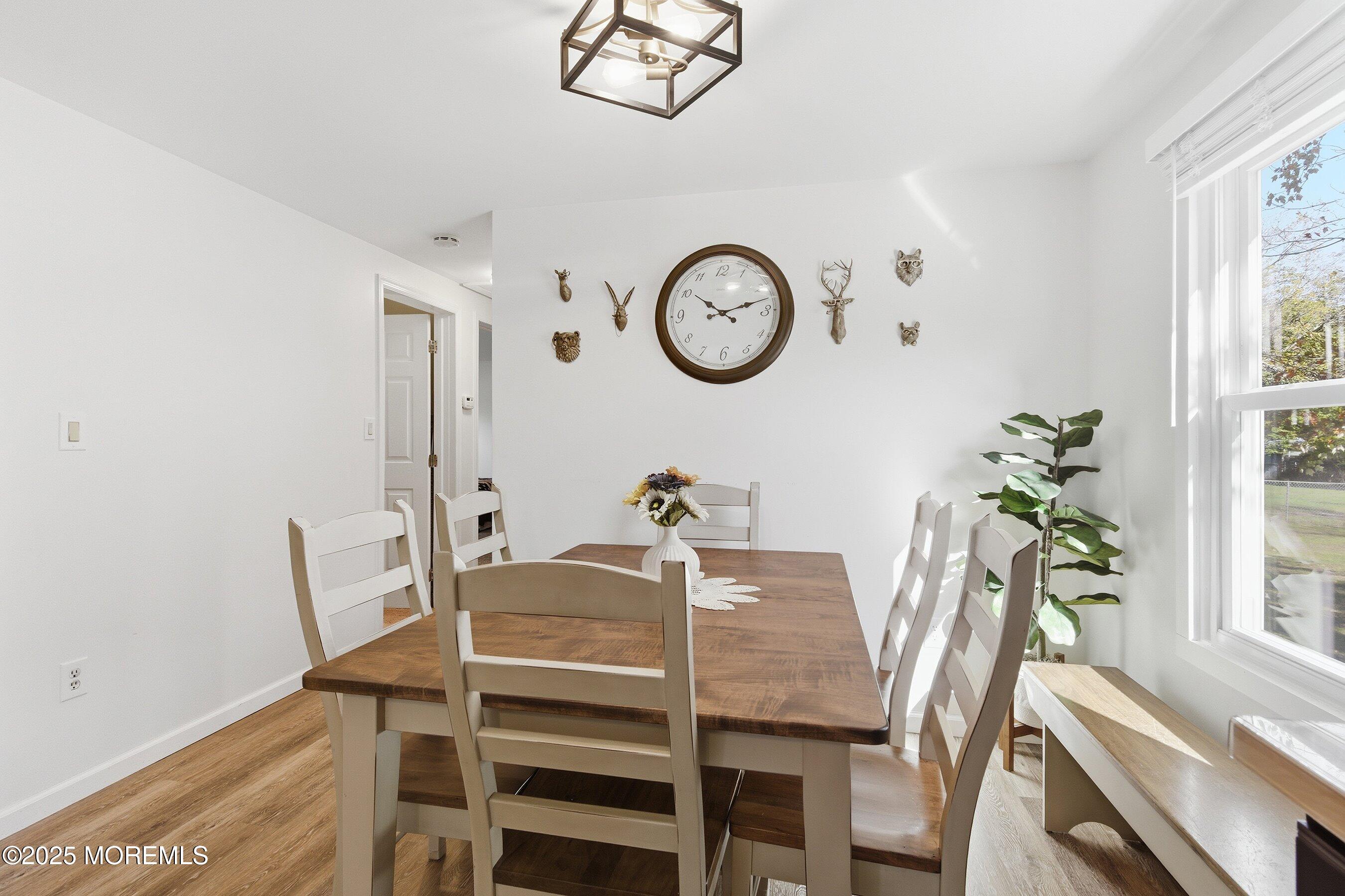 145 Cassville Road Jackson, NJ 08527 - Photo 13 of 35 a view of a dining room with furniture a potted plant and wooden floor