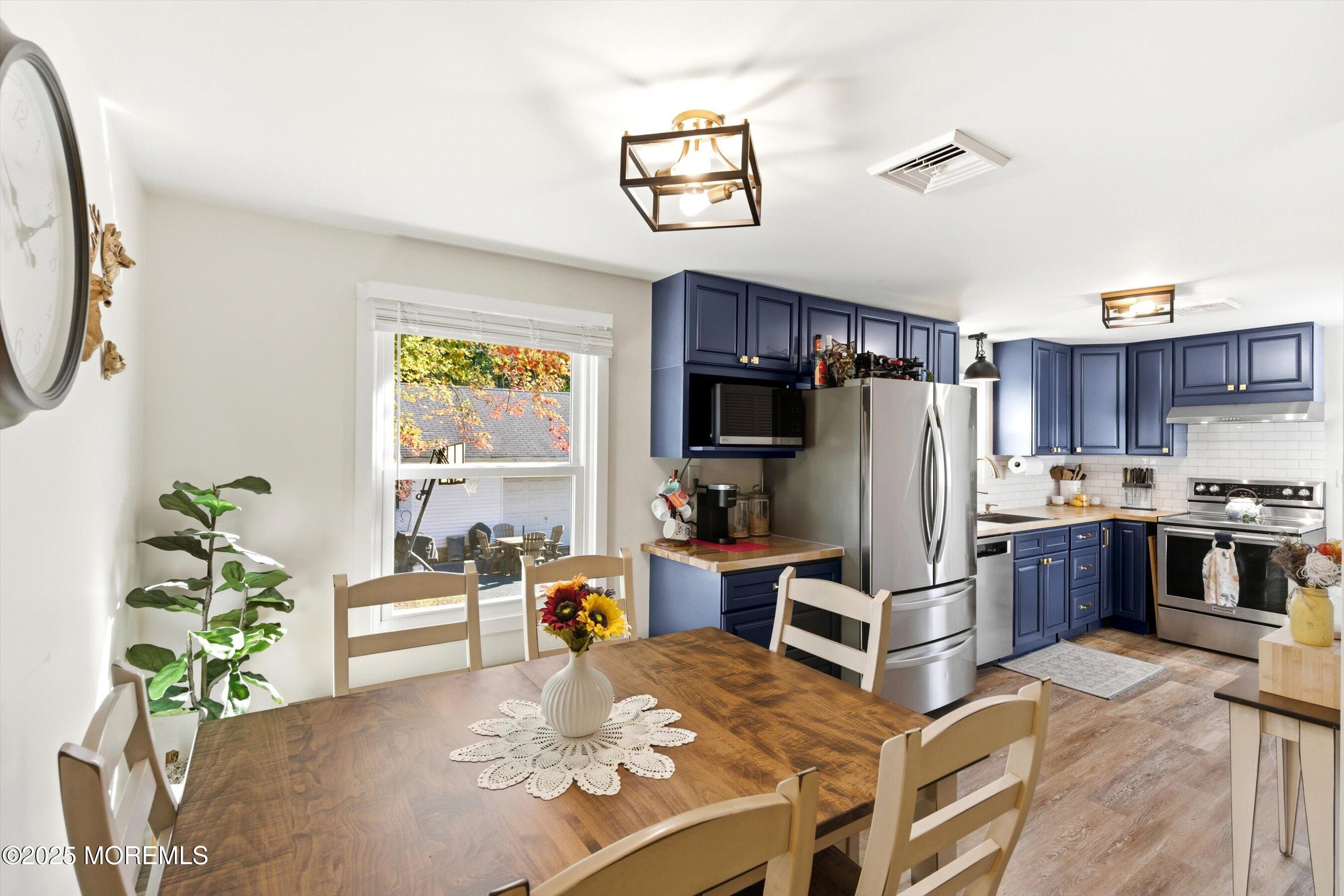 145 Cassville Road Jackson, NJ 08527 - Photo 15 of 35 a living room with stainless steel appliances furniture a chandelier and a dining table