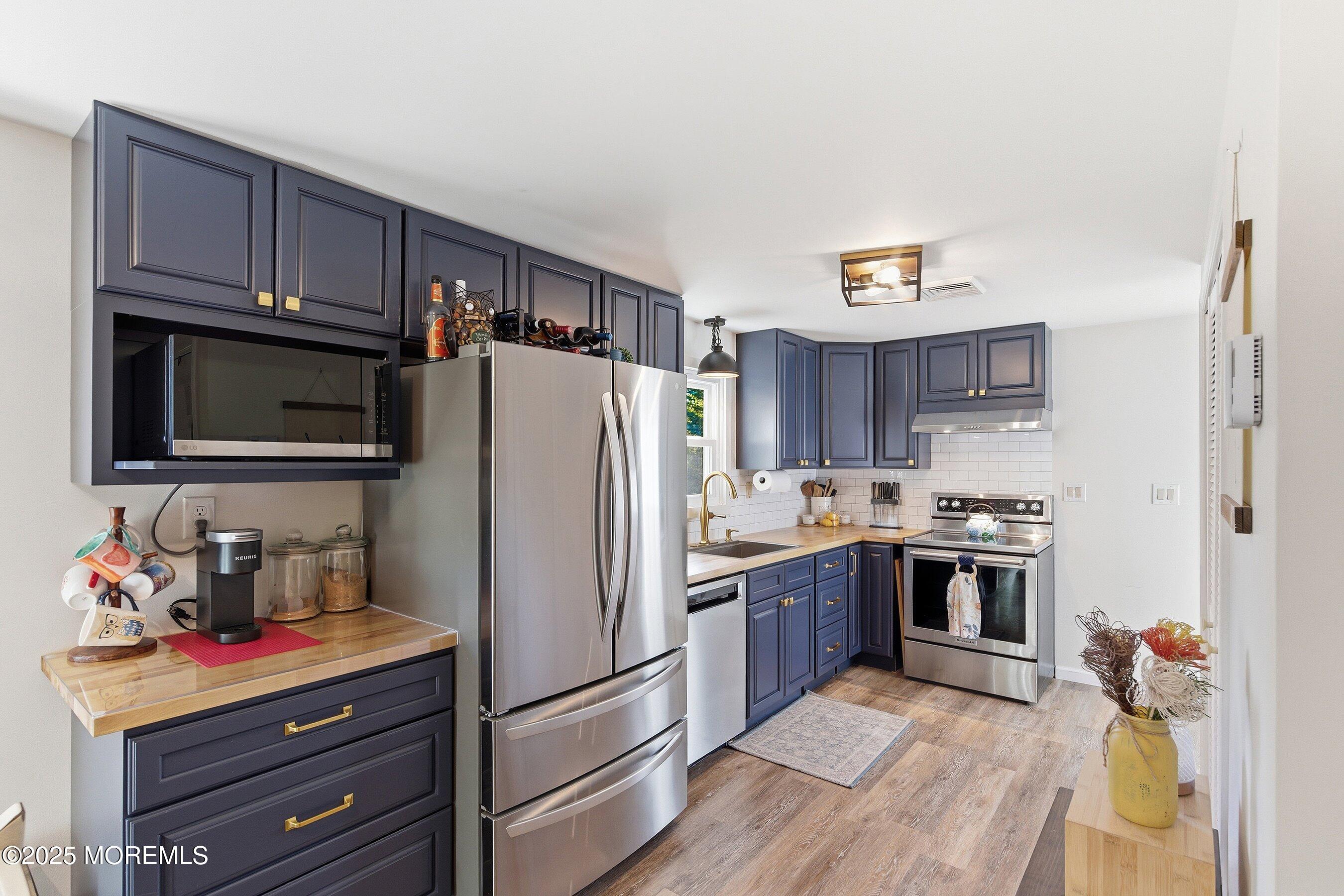 145 Cassville Road Jackson, NJ 08527 - Photo 16 of 35 a kitchen with stainless steel appliances granite countertop a refrigerator stove and sink