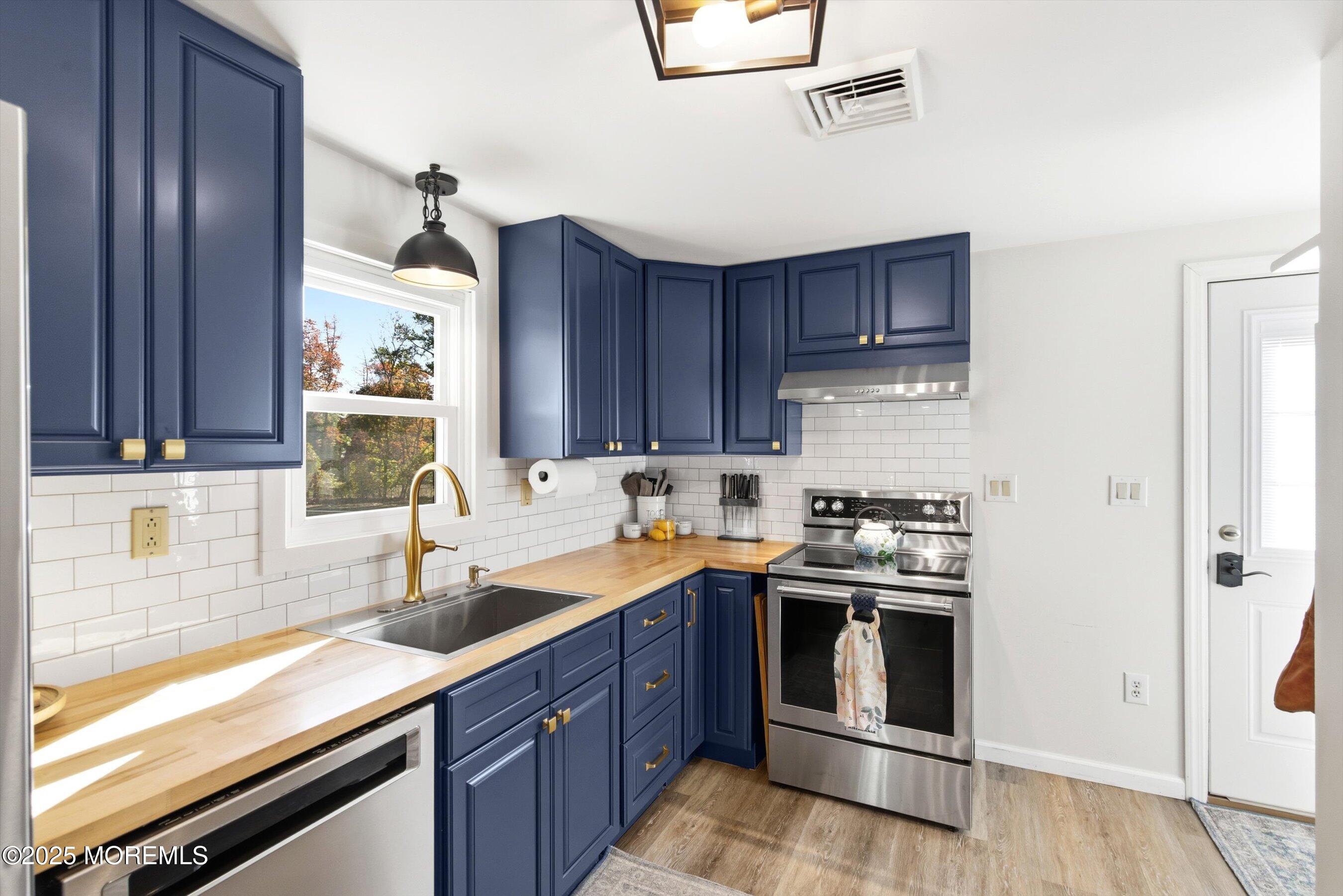 145 Cassville Road Jackson, NJ 08527 - Photo 17 of 35 a kitchen with stainless steel appliances granite countertop a sink stove and refrigerator