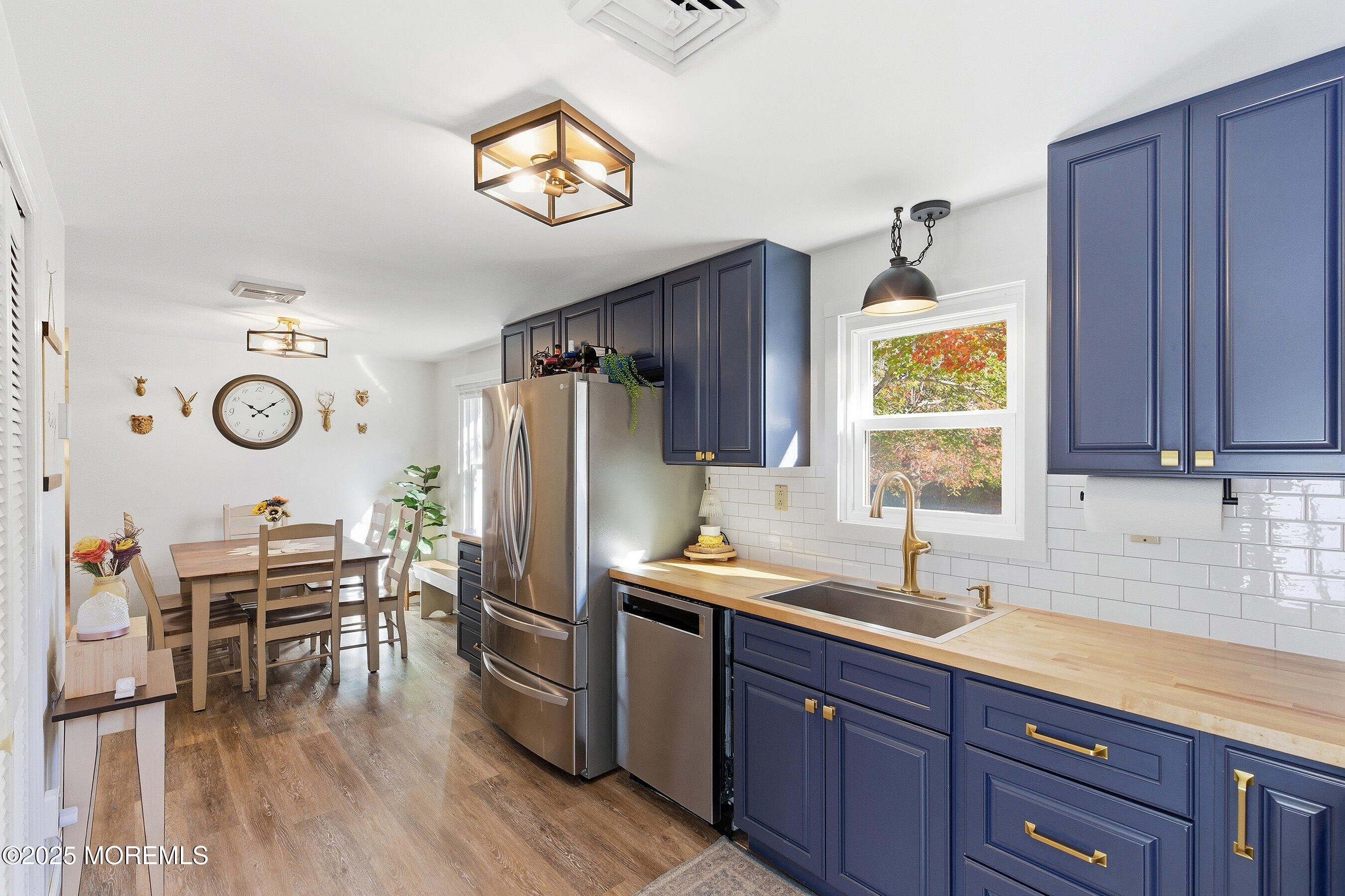145 Cassville Road Jackson, NJ 08527 - Photo 18 of 35 a kitchen with stainless steel appliances a stove a refrigerator and a center island with wooden floor