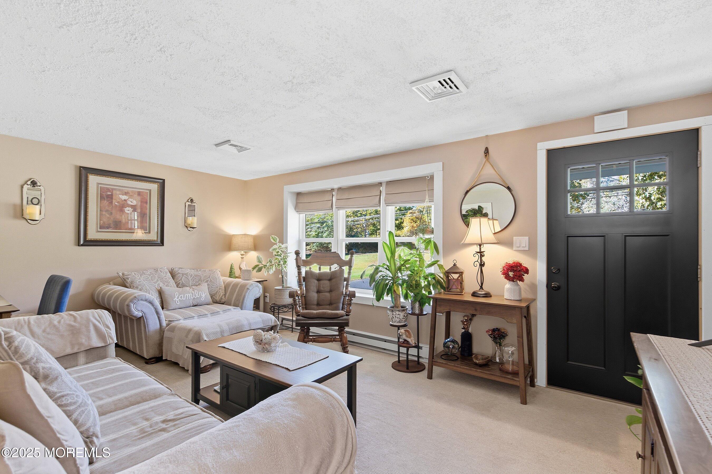 145 Cassville Road Jackson, NJ 08527 - Photo 8 of 35 a living room with furniture and a fireplace