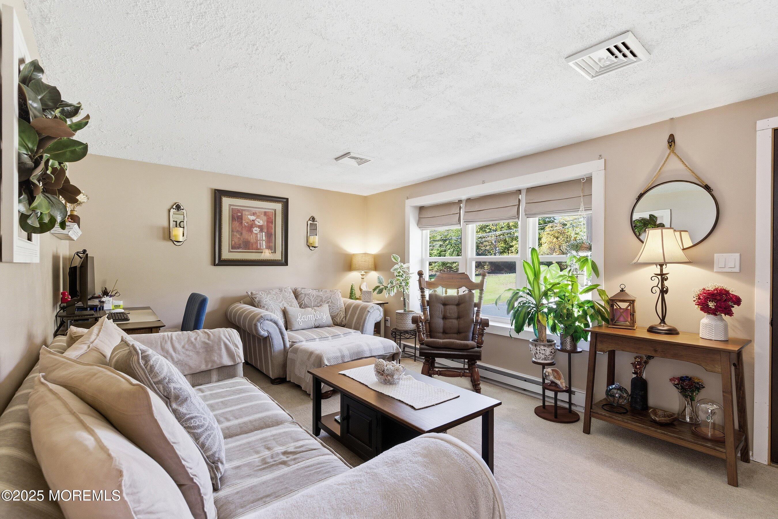 145 Cassville Road Jackson, NJ 08527 - Photo 9 of 35 a living room with furniture and a large window