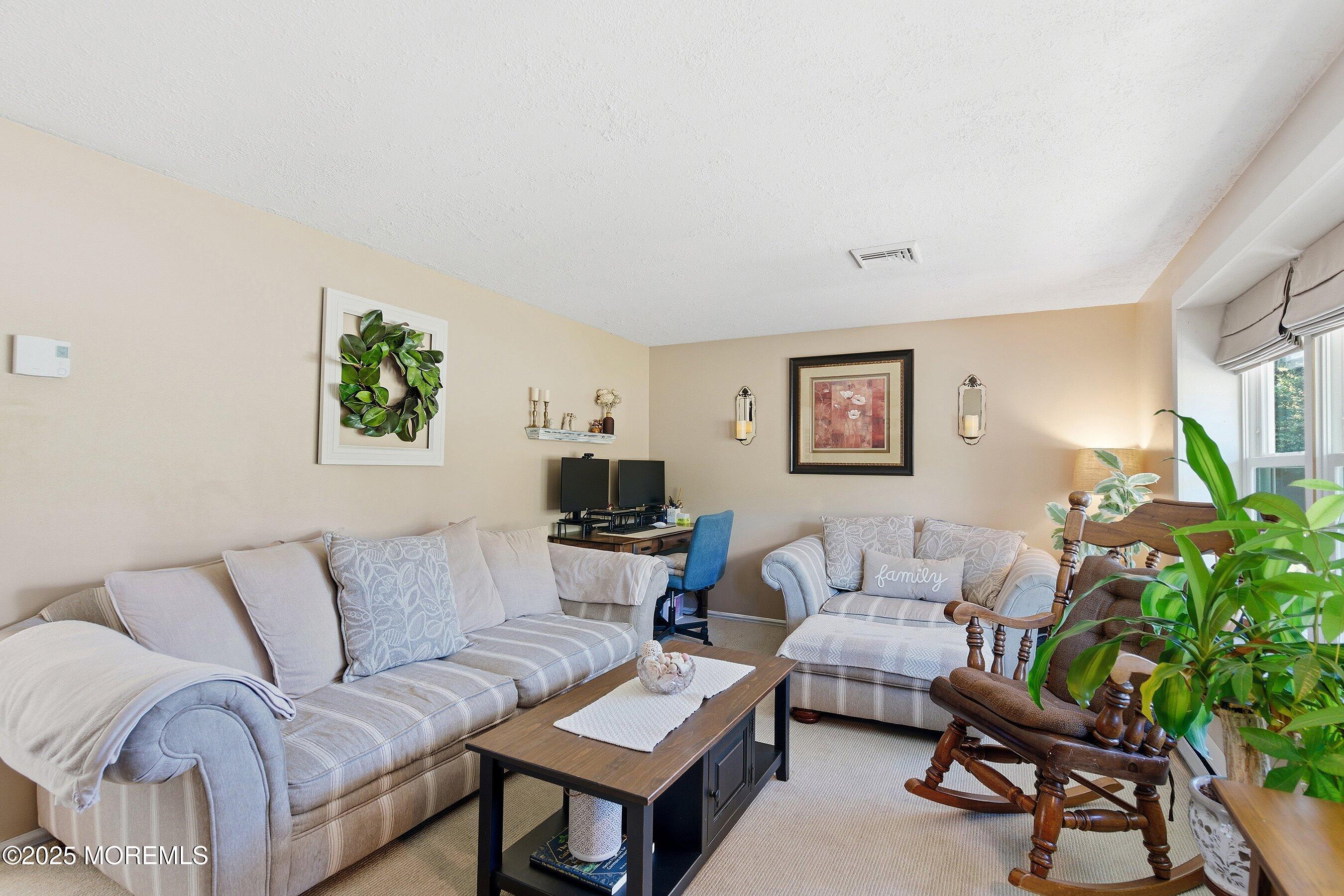 145 Cassville Road Jackson, NJ 08527 - Photo 10 of 35 a living room with furniture and a potted plant