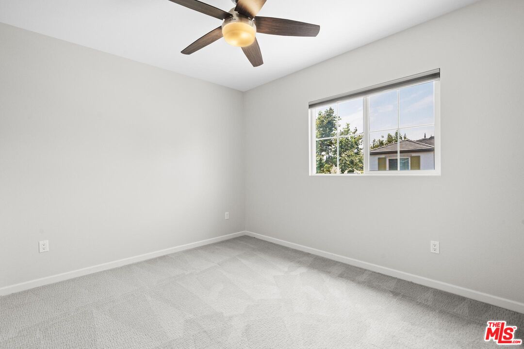 15603 Lilli Way Van Nuys, CA 91406 - Photo 11 of 15 an empty room with a window and a fan