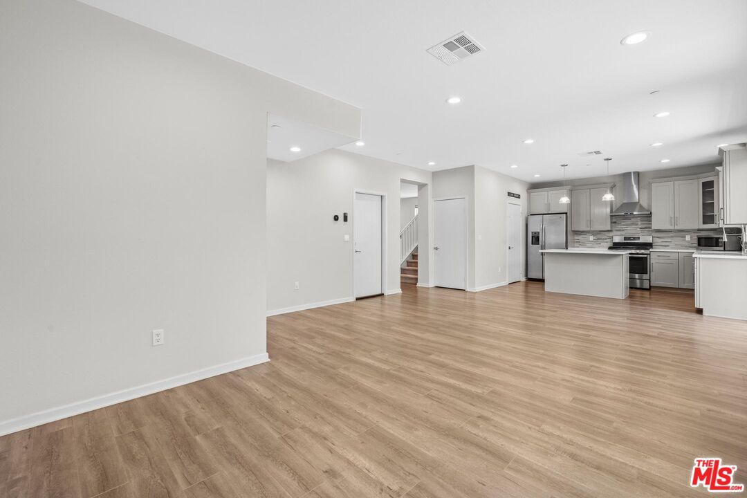 15603 Lilli Way Van Nuys, CA 91406 - Photo 2 of 15 a view of kitchen with kitchen island microwave and stove