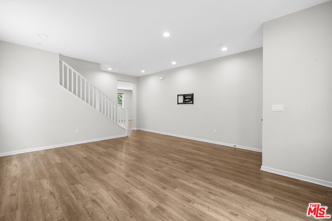 15603 Lilli Way Van Nuys, CA 91406 - Photo 5 of 15 a view of an empty room with wooden floor