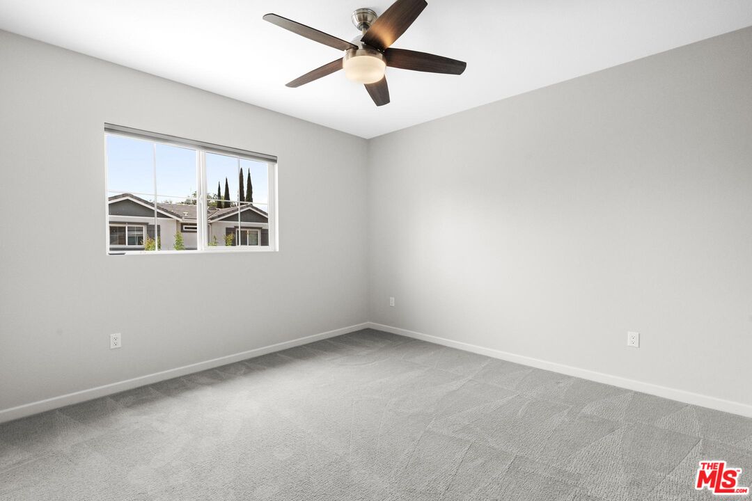 15603 Lilli Way Van Nuys, CA 91406 - Photo 8 of 15 a view of a big room with windows and ceiling fan