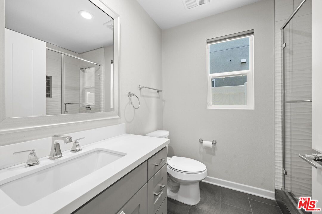 15603 Lilli Way Van Nuys, CA 91406 - Photo 10 of 15 a bathroom with a toilet a sink and mirror