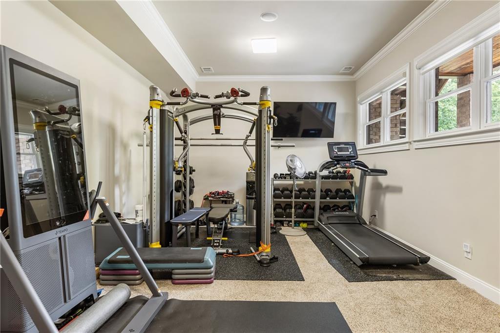 14560 Wood Road Milton, GA 30004 - Photo 52 of 74 a room with gym equipment and a flat screen tv