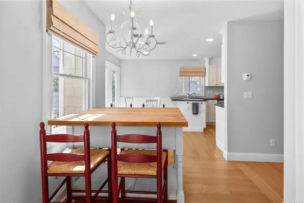 a view of a dining room with furniture and chandelier