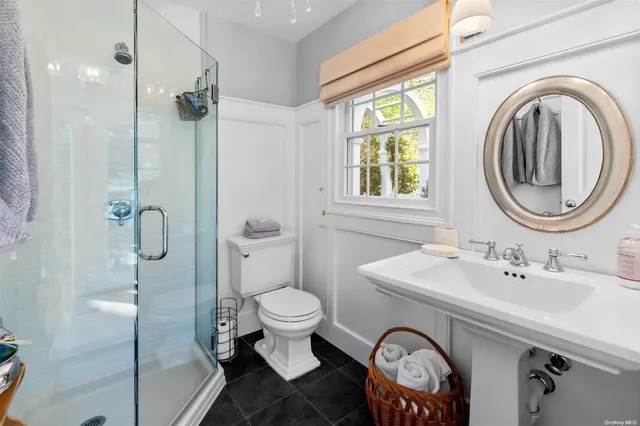 a bathroom with a sink toilet and a mirror