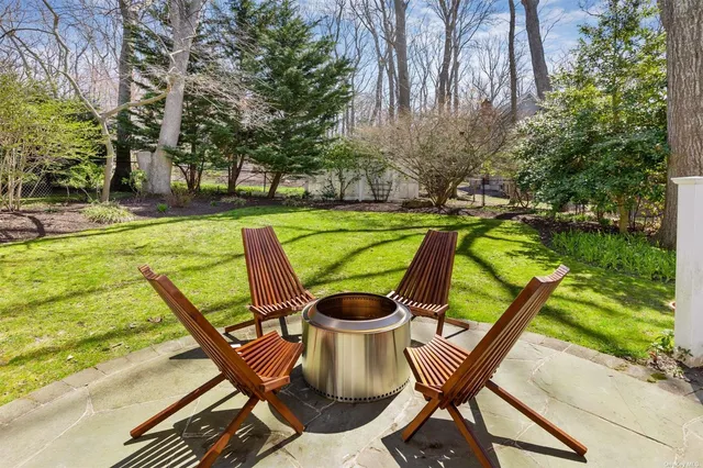 a view of a swimming pool with a patio and a backyard