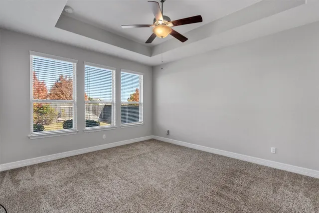a view of an empty room and a ceiling fan