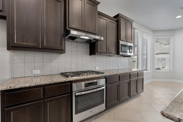 a kitchen with a sink a counter space and a wooden floor