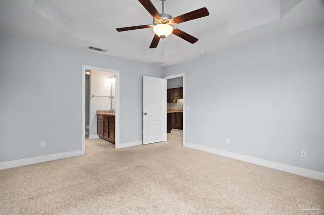 a bathroom with a granite countertop sink a large mirror and a vanity