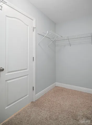 a view of empty room with wooden floor and fireplace