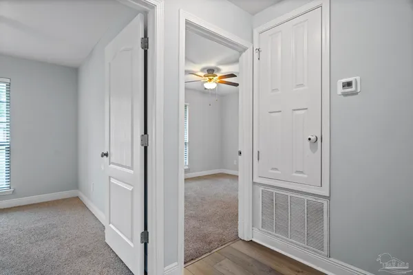 an empty room with a window and a fan