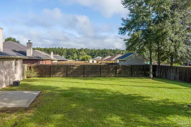a front view of a house with yard and swimming pool