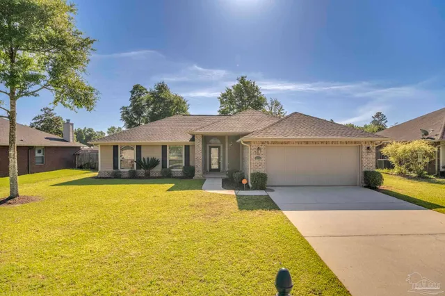 a sign that is sitting on a brick wall