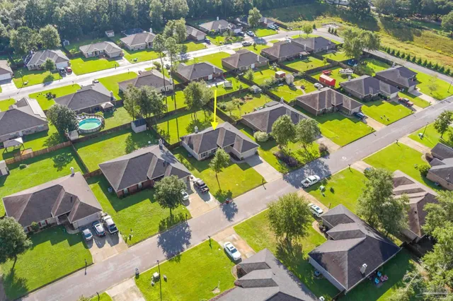 a backyard of a house with lots of green space and plants