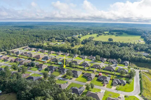 a view of a city with green field