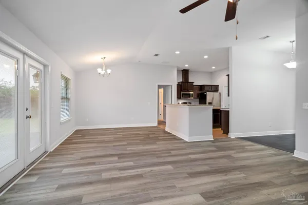 en empty room with wooden floor and window