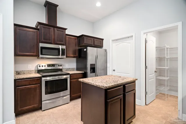 a kitchen with a sink stove and refrigerator