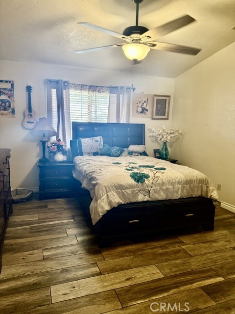 13375 Rincon Road Apple Valley, CA 92308 - Photo 28 of 72 a bedroom with a bed chandelier and a window